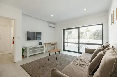 a living room with a couch and a tv at Pateo In Lapa City Center by Vacationy in Porto