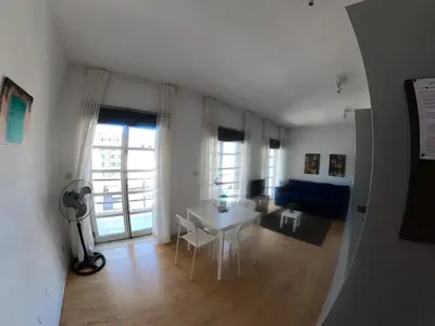 a living room with a white table and a blue couch at Santa Catarina´s Soul in Porto