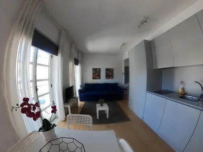 a kitchen and a living room with a blue couch at Santa Catarina´s Soul in Porto