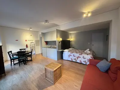 a living room with a bed and a dining table at Santa Catarina´s Soul in Porto