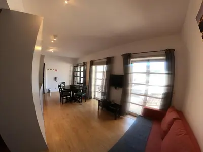 a living room with a couch and a dining room table at Santa Catarina´s Soul in Porto
