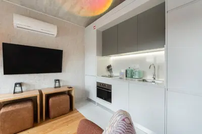a living room with a tv and a kitchen at GuestReady - Elegant living in Porto city centre in Porto