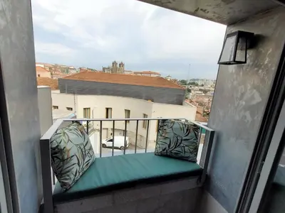 a balcony with a green bench on a building at GuestReady - Elegant living in Porto city centre in Porto