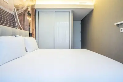 a large white bed in a room with a window at João IV Jewel Retreat by LovelyStay in Porto