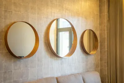three mirrors hanging on a wall with a couch at João IV Jewel Retreat by LovelyStay in Porto