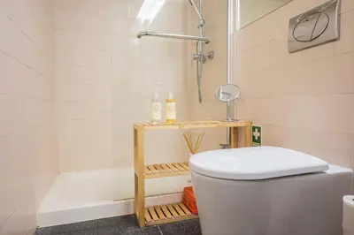 a bathroom with a shower and a toilet and a tub at Santo António Loft - Porto Perfect in Porto