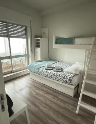 a bedroom with a bunk bed and a ladder at Acquamarina Porto in Porto