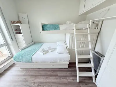 a bedroom with two bunk beds and a ladder at Acquamarina Porto in Porto