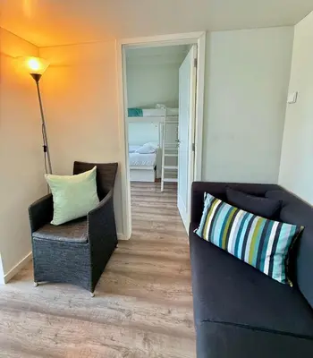 a living room with a couch and a chair at Acquamarina Porto in Porto