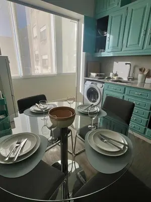 a kitchen with a glass table with plates and silverware at Acquamarina Porto in Porto