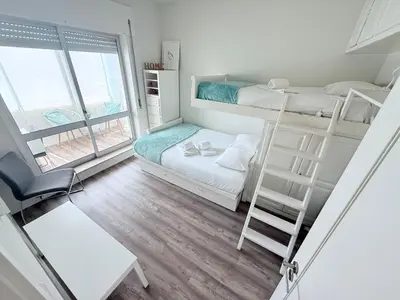 a small room with two bunk beds and a ladder at Acquamarina Porto in Porto