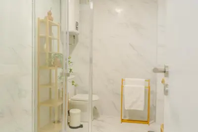 a bathroom with a toilet and a glass shower at Porto Serenity loft. in Porto