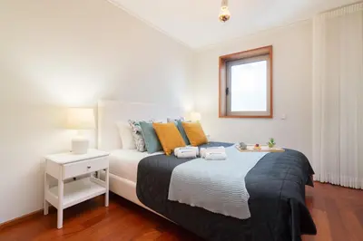 a bedroom with a large bed and a window at Host Wise - Gorgeous Spacious Flat - Ace Location in Porto