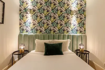 a bedroom with a large bed with two side tables at D&S - Alvares Cabral in Porto