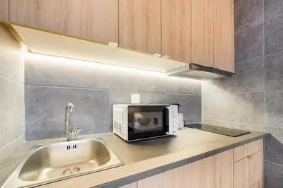 a kitchen counter with a microwave and a sink at GuestReady - A pleasant stay in Porto in Porto