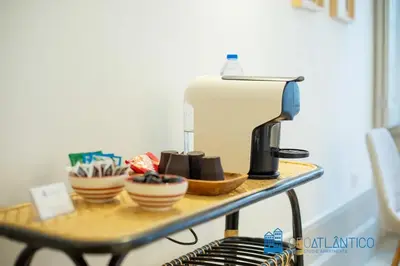 a table with a coffee maker and cups on it at Porto Almada Design Loft in Porto