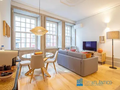 a living room with a couch and a table at Porto Almada Design Loft in Porto