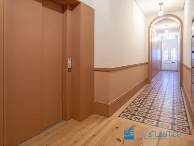 an empty hallway with a door and a tile floor at Porto Almada Design Loft in Porto