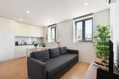 a living room with a couch and a kitchen at GuestReady - King House 2 in Porto
