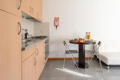 a small kitchen with a table and a sink at Host Wise - Comfy Charming Flat w Netflix - Ace Location in Porto