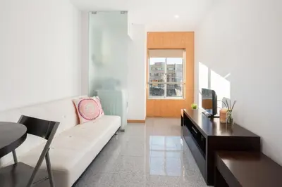 a living room with a couch and a table at Host Wise - Comfy Charming Flat w Netflix - Ace Location in Porto