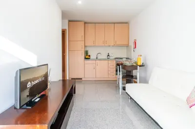 a living room with a television and a kitchen at Host Wise - Comfy Charming Flat w Netflix - Ace Location in Porto