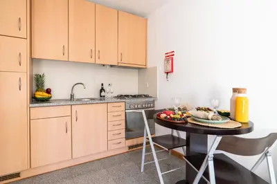 a kitchen with a table with a plate of food on it at Host Wise - Comfy Charming Flat w Netflix - Ace Location in Porto