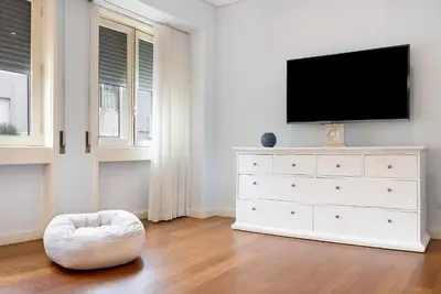 a bedroom with a white dresser with a flat screen tv at Apartment Boutique Santa Catarina 2 in Porto