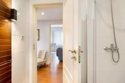 a bathroom with a shower and a white door at Apartment Boutique Santa Catarina 2 in Porto