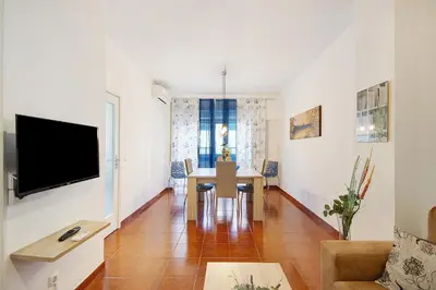 a living room with a table and a tv at Trindade Porto City Centre in Porto