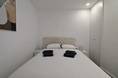 two black bags sitting on top of a white bed at DOUROVIEW in Porto