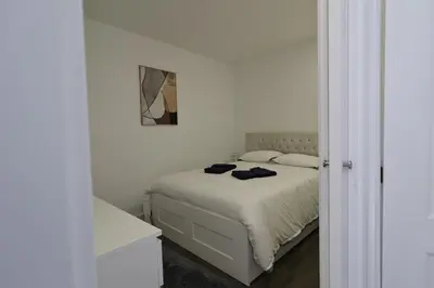 a white bedroom with a bed and a mirror at DOUROVIEW in Porto