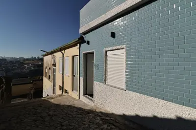 a blue brick building with a door and a window at DOUROVIEW in Porto