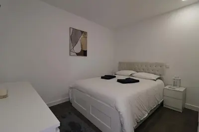 a bedroom with a white bed with two towels on it at DOUROVIEW in Porto