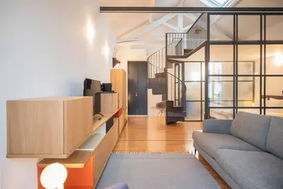 a living room with a couch and a table at Charmy Studio Porto in Porto