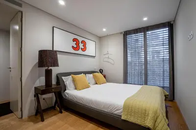 a bedroom with a bed and a window at Primrose 1BR Delight w Parking by LovelyStay in Porto