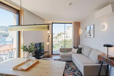 a living room with a couch and a table at Feel Porto Firmeza Coworking & Flats in Porto
