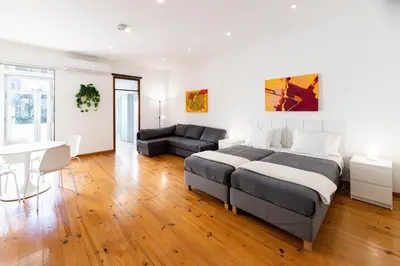 a bedroom with a bed and a couch and a desk at PORTO GARDEN YARD APARTMENT in Porto