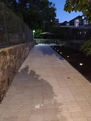 a stone patio with a building in the background at PORTO GARDEN YARD APARTMENT in Porto