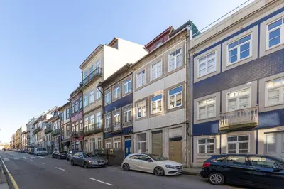 a row of buildings on a street with parked cars at PORTO GARDEN YARD APARTMENT in Porto