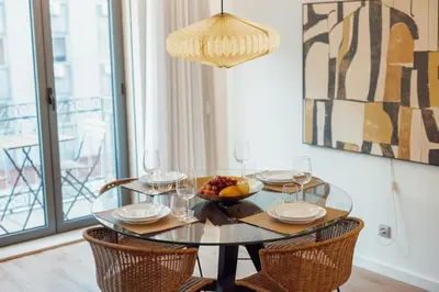 a glass table with a bowl of fruit and wine glasses at OPORTO GUEST Renovato Luxus Flat w/ parking in Porto