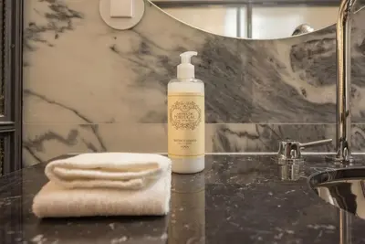 a bathroom with a bottle of soap and a towel at Touchy Porto in Porto