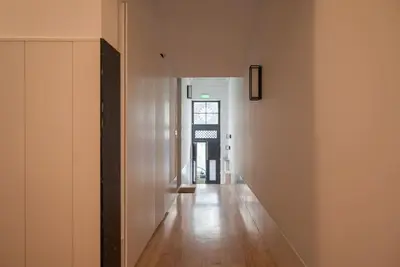 an empty hallway of a building with a wooden floor at Touchy Porto in Porto