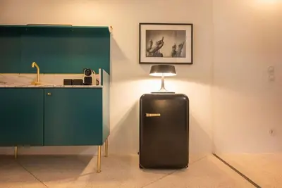 a black refrigerator in a room next to a counter at Touchy Porto in Porto