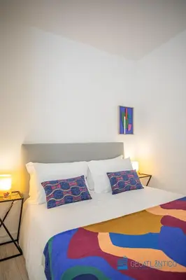 a bedroom with a large bed with two pillows at Porto Formosa Central Lofts in Porto