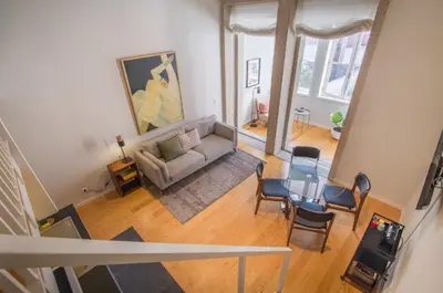 an overhead view of a living room with a couch and chairs at Almada 151 Porto in Porto