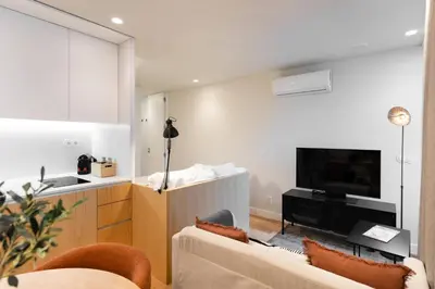 a living room with a couch and a tv at Feel Porto Corporate Housing Boavista in Porto