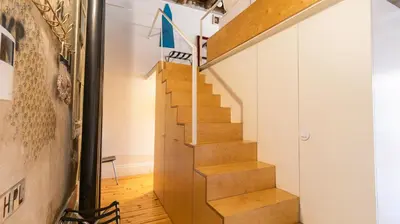 a staircase in a house with wooden floors at Eccentric Mouzinho Mezzanine by LovelyStay in Porto