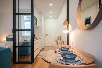 a living room with a table and a mirror at Santa Catarina Charm Apartment Downtown near Metro in Porto