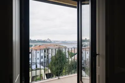 a room with a view of a city from a window at Glamour by the River in Porto